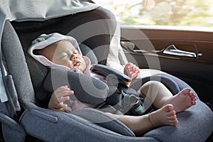 Close Up Asian cute newborn baby sleeping in modern car seat.