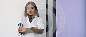 close up of asian female doctor standing arms crossed with stethoscope. Medical and Healthcare concept