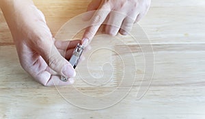 Close up of Asian female hands cutting fingernails. Young woman clipping her nails photo