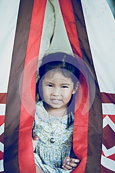 Close Up of asian little girl with wigwam Indians