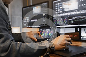 close-up of an Asian male movie video editor or coloris in his creative office studio.