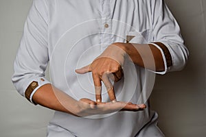 Close up Asian man shows hand gestures it means STAND isolated on white background. American sign language