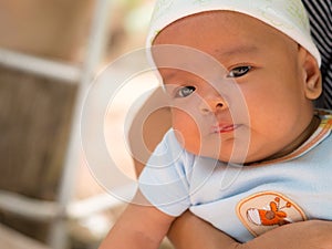 Close up, asian newborn baby in mother`s arms.