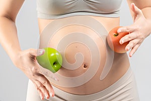 Close up asian pregnant woman eating fruit for her and infant healthy