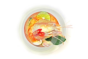 Close up Asian Spicy soup with shrimp in white bowl , famous Thai food cuisine calling Tom Yum Kung
