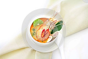 Close up Asian Spicy soup with shrimp in white bowl , famous Thai food cuisine calling Tom Yum Kung
