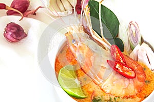 Close up Asian Spicy soup with shrimp in white bowl , famous Thai food cuisine calling Tom Yum Kung