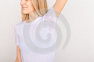 Close-up asian woman with hyperhidrosis sweating. Young asia woman with sweat stain on her clothes against grey