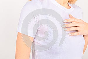 Close-up asian woman with hyperhidrosis sweating. Young asia woman with sweat stain on her clothes against grey