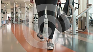 Close up of Asian woman legs walking in fitness sport club gym and preparing to muscular weight workout trainning. People