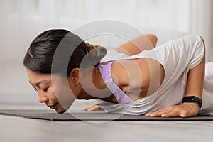 Close up.Asian woman practising yoga, Cobra exercise, Bhujangasana stance, working out, and wearing sportswear