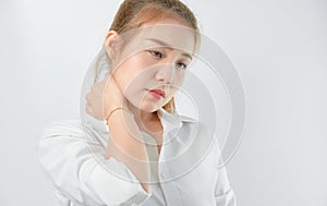 Close-up of Asian women acute pain in a neck, Health care and medical concept. gray background.