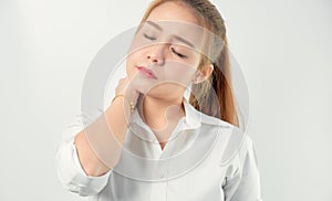 Close-up of Asian women acute pain in a neck, Health care and medical concept. gray background.