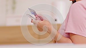 Close up Asian young woman using credit card for pay online shopping on mobile phone.Hand typing credit card number to buying