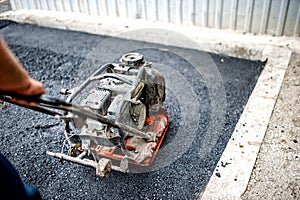 Close-up of asphalt worker in construction site