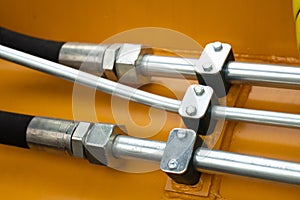 Close-up of an assembly with hydraulic pipes and couplings on a truck