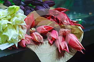 Close-up assortment of flower shop, red, pink, purple, white tulips vase with lavender in the foreground, selective focus