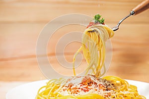 Close-up of asta spaghetti with tomato sauce, olives and garnish