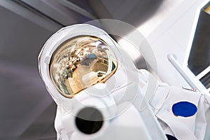 Close-up of astronaut in white spacesuit, blurred background
