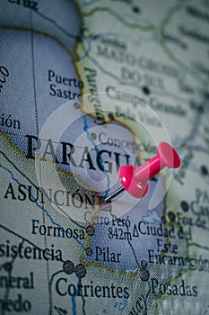 Close up of AsunciÃ³n, Paraguay pin pointed on the world map with a pink pushpin