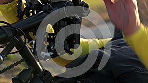 Close up of an athlete with disability preparing hand bike for training.