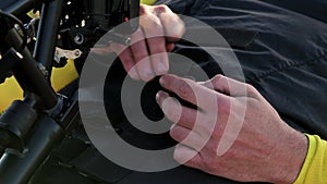 Close up of an athlete with disability preparing hand bike for training.