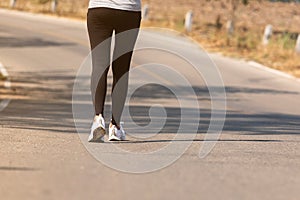 Close up Athlete running woman wearing Exercise pants and running shoe on the road,Runner woman traning in the morning.Walking for