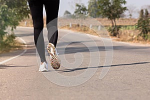 Close up Athlete running woman wearing Exercise pants and running shoe on the road,Runner woman traning in the morning.Walking for