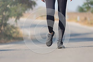 Close up Athlete running woman wearing Exercise pants and running shoe on the road,Runner woman traning in the morning.Walking for