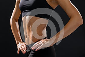 Close up of athletic female abs in sportswear