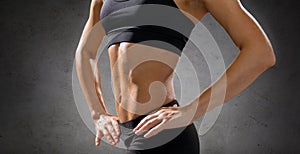 Close up of athletic female abs in sportswear