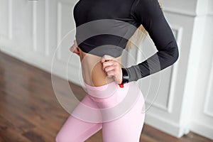 Close-up athletic female body slim elegant waist of a stylish fitness model with perfect figure lines after an effective