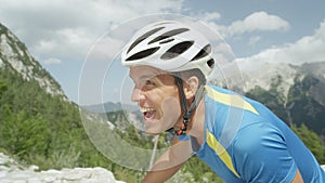 CLOSE UP: Athletic man going through grueling exhaustion during cycling tour.