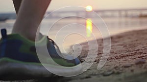 Close up of athletic man running on the beach at beautiful sunset in slowmotion. 1920x1080