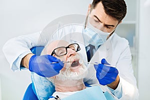 Close up of attentive stomatologist in the dental office