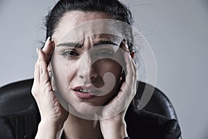 Close up attractive business woman working at office in stress suffering intense headache