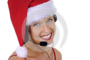 Close up of attractive female call center telephonist with telephone headset and Christmas Santa hat