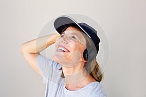 Close up attractive middle age woman smiling with headphones