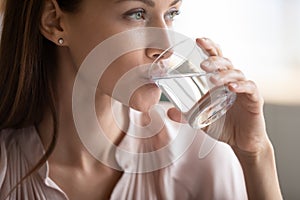 Close up attractive woman drinking pure fresh mineral water