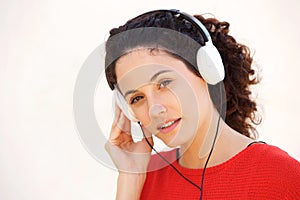 Close up attractive young woman listening to music with headphones