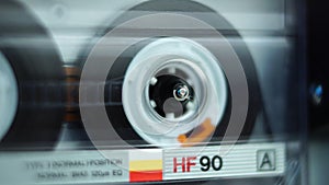 Close Up of Audio Cassette Tape Reel Playing in Deck Player