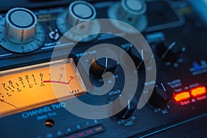 Close Up of Audio Mixing Console with Illuminated VU Meter