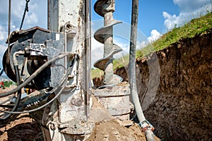 Close up of auger, industrial drilling rig making a hole