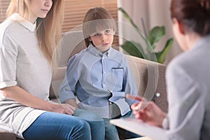 Autistic child listening to therapist photo