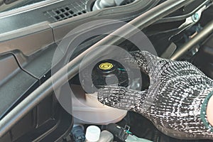 Close up of Auto mechanic checking brake fluid, Car maintenance service