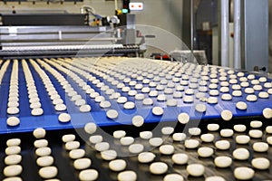 Close up of automated biscuit cookies shape forming machine. Selective focus. machine for making cookies in the factory