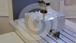 Close up: automated turning milling machine cutting metal workpiece at factory