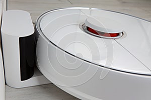 Close-up of the automatic charging of the robot vacuum cleaner.