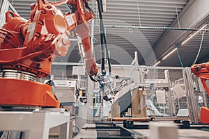 Close up of automatic robot arms in automotive industry, factory production of headlamps for a cars, industrial concept