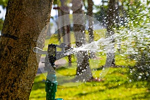 Close-up of automatic sprinkler irrigation sprinklers in the park
